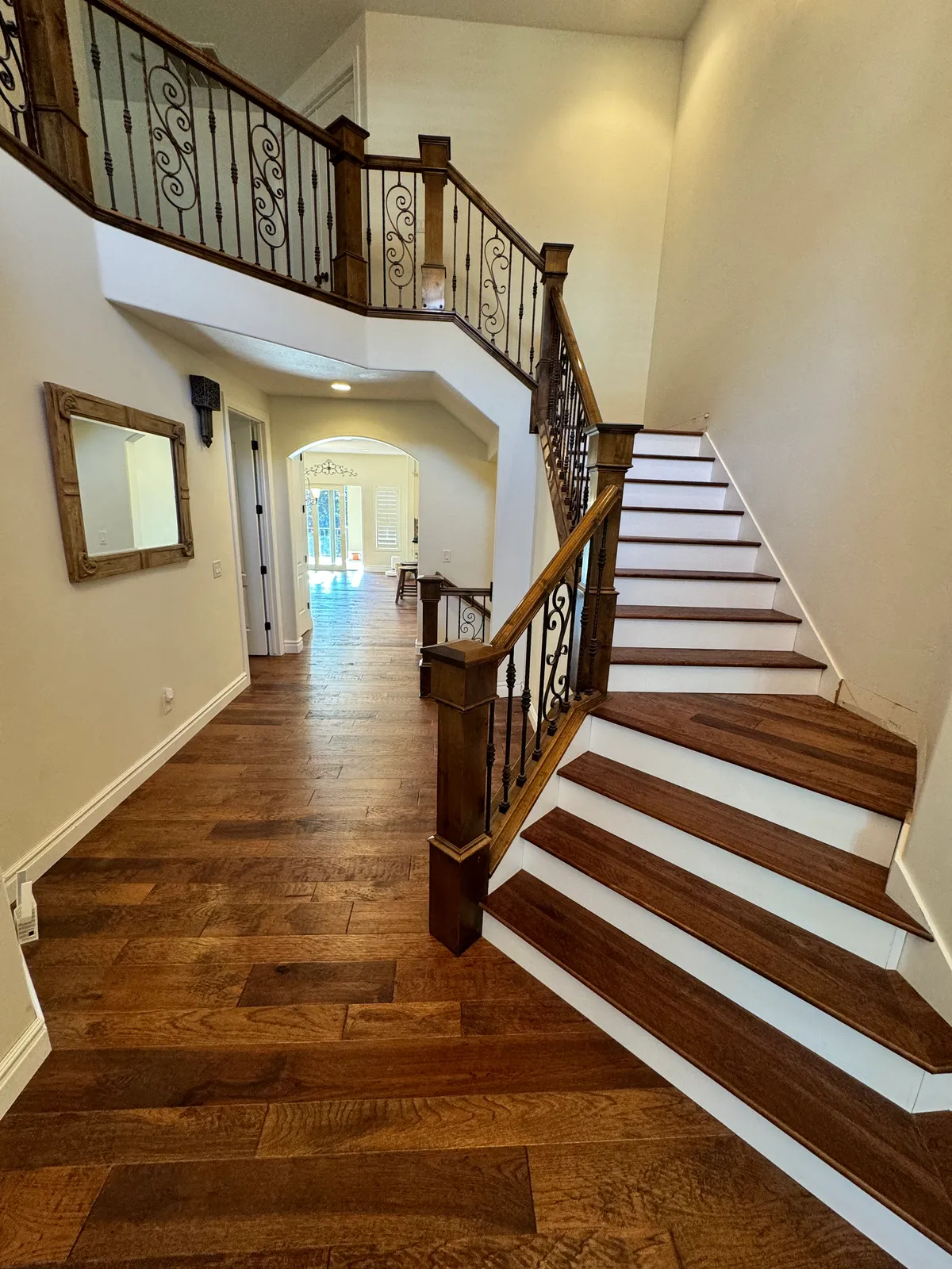 Grand entryway with curved staircase and hardwood floors