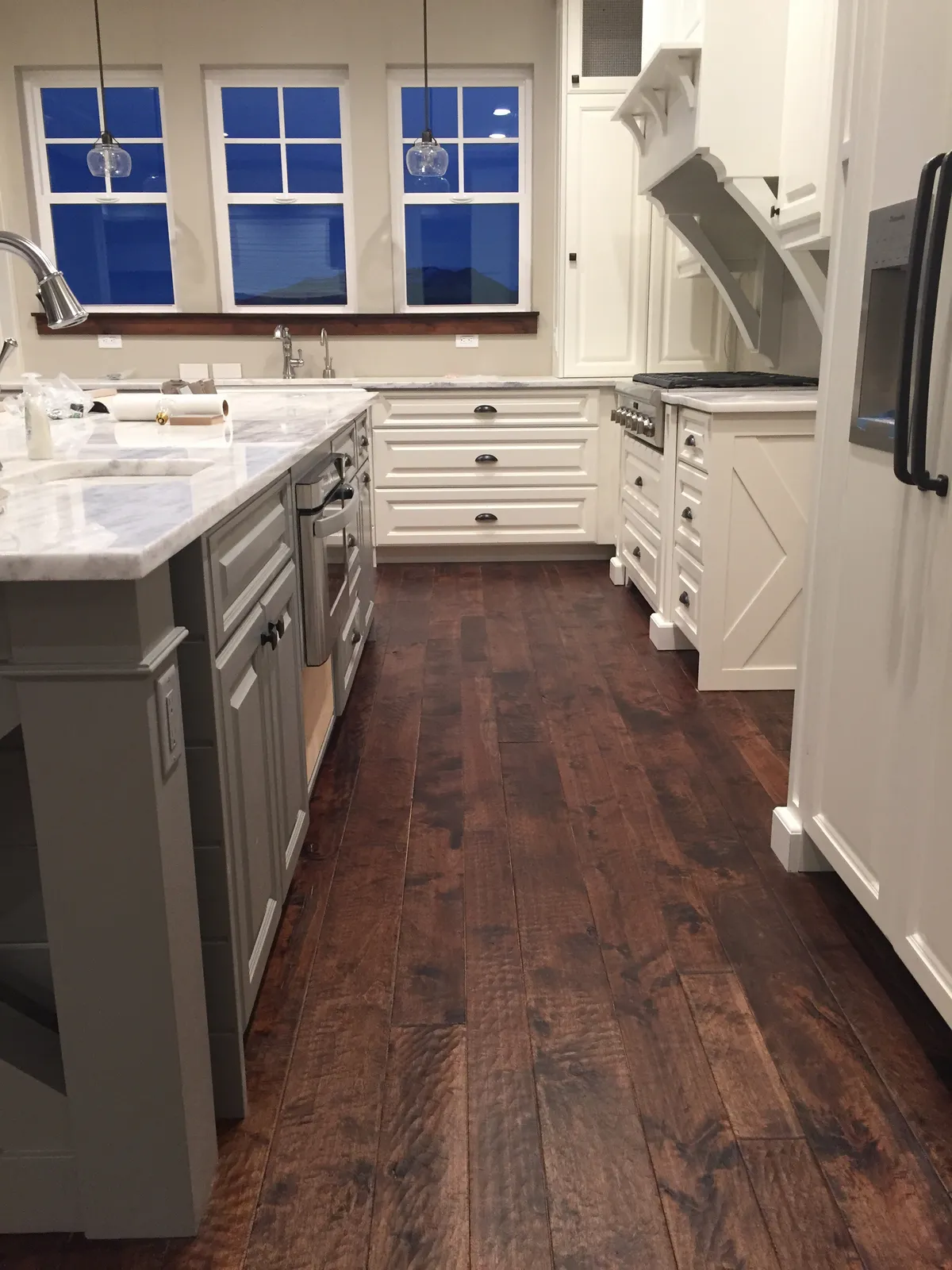 Dark hardwood kitchen with white cabinets