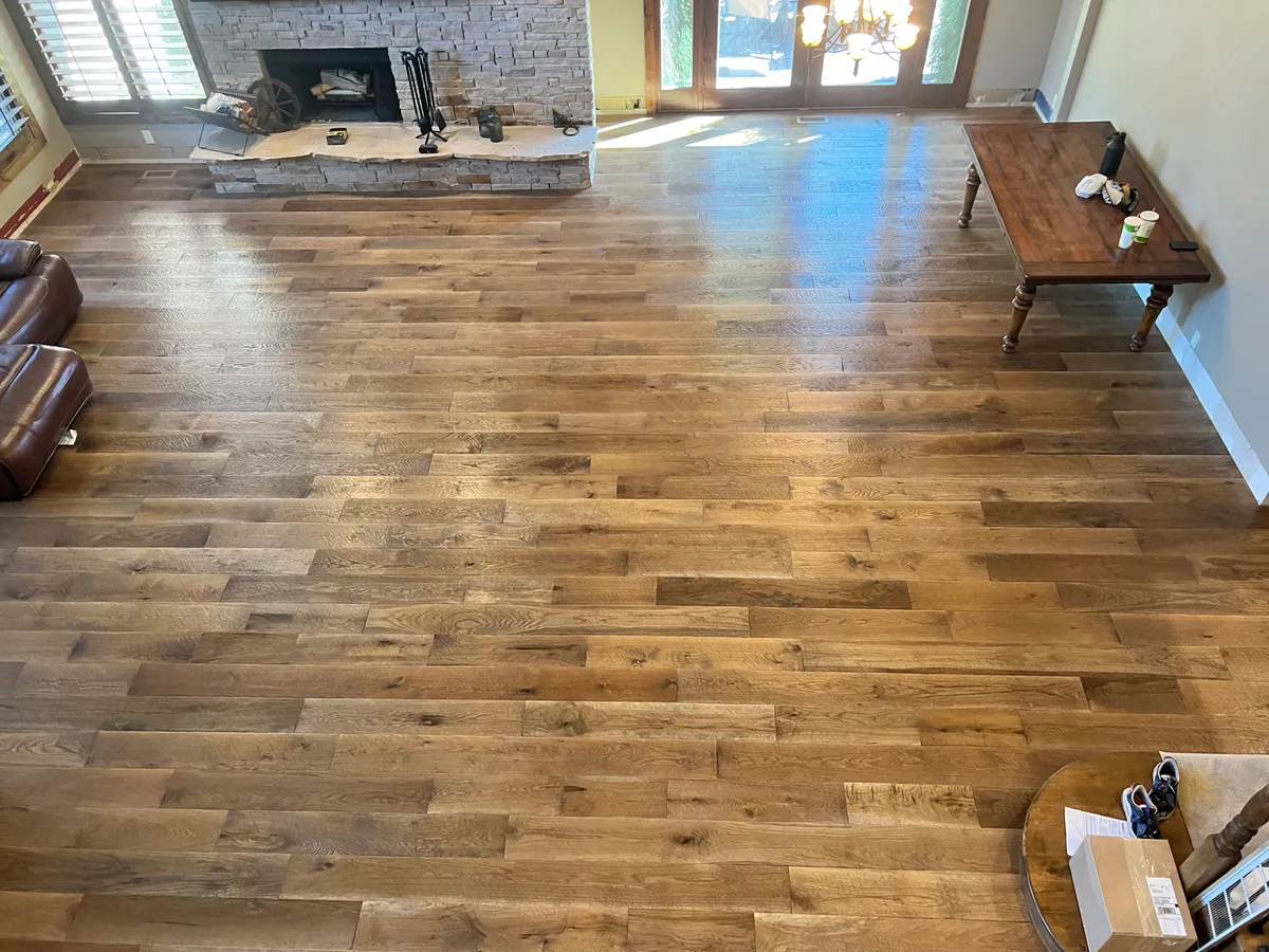 Living room with stone fireplace and hardwood floors