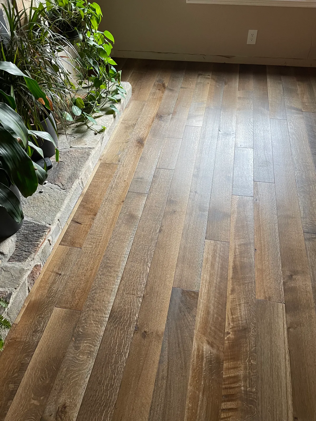 Hardwood floor detail showing seasonal gapping in a Utah home